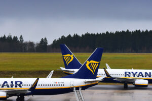 Two Ryanair aircraft parked on the apron at an airport, positioned tail-to-tail with Ryanair logos visible on both aircraft tails.
