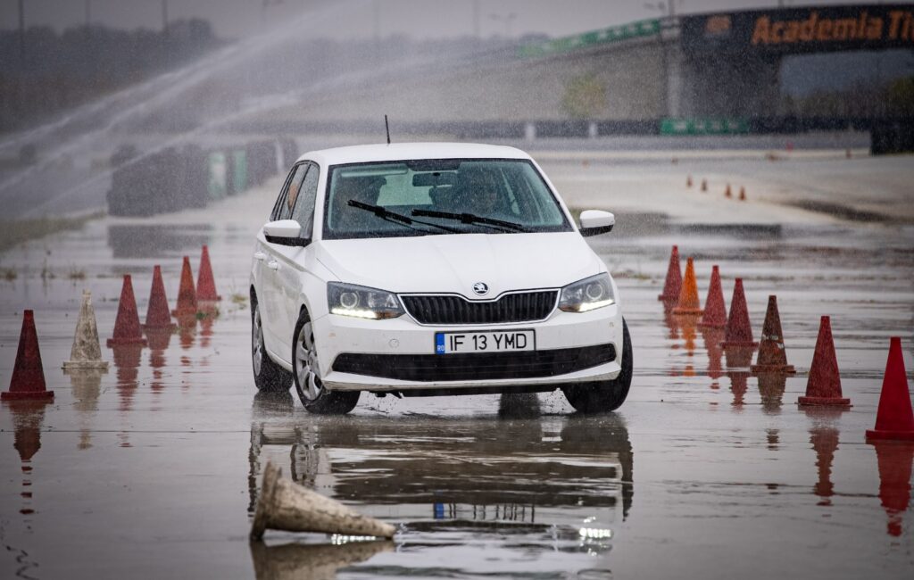 Defensive driving exercise on a wet training course at Academia Titi Aur